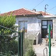 One Storey House And A New Building In Common Yard